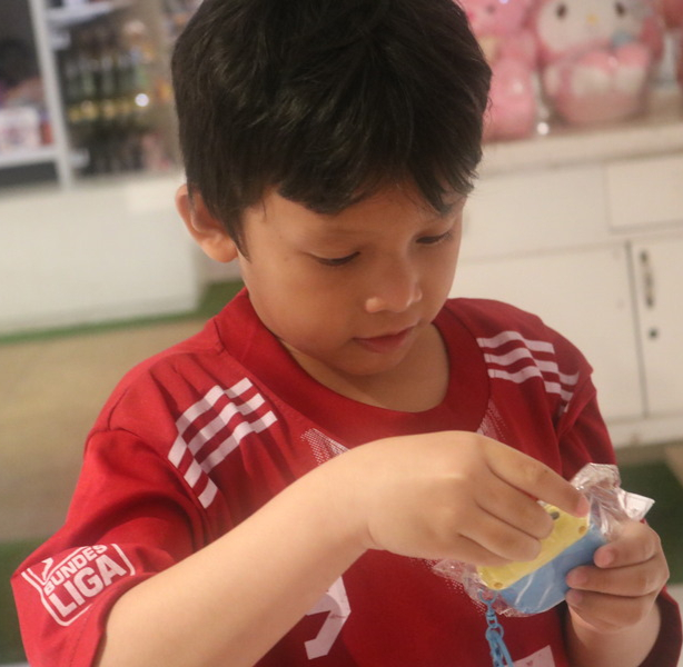 Syamil wearing a red football t-shirt